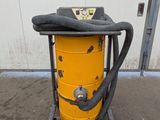 a yellow dust collector with a black hose on top of it