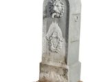 a stone statue of a man and a woman on a pedestal