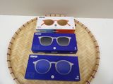 two pairs of sunglasses sitting on top of a basket on a table