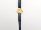 a gold watch with a black leather strap and a gold face
