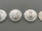 a group of five silver coins sitting on top of a table