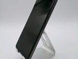 a cell phone that is on a stand on a table