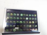a display case with a lot of green glass bottles