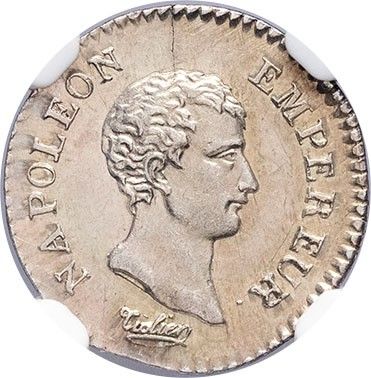 a silver coin with the head of a man in profile