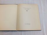 an open book sitting on top of a white sheet covered table