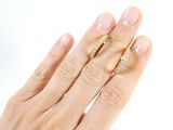 a woman ' s hand with two gold rings on it
