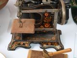 an old sewing machine on a table next to other items