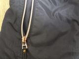 a close up of a black jacket with a zipper on it