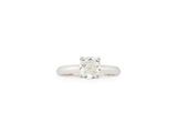 a white gold ring with a single diamond in the center