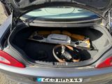 a car with its trunk open and a steering wheel in the trunk