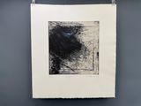 a black and white drawing hanging on a wall