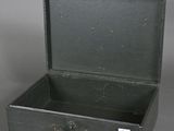 a black suitcase that is open on a gray surface