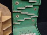 a green chest of drawers next to a stack of books