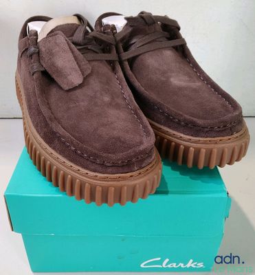 the shoes are in a box on a white surface