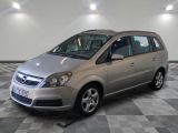 the small silver car is parked in a large room