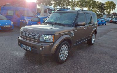 a brown land rover parked in a parking lot