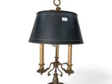 an antique brass table lamp with a black shade