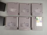 six nintendo game cartridges sitting on a table next to each other