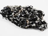 a close up of a piece of black and white rock on a white surface