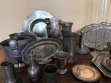 a table with a lot of silver dishes and cups on it