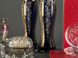 three vases and a book sitting on a table