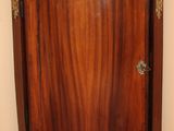 a corner cabinet with a marble top in the corner