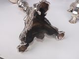 a silver figurine of a bear and a turtle on a table