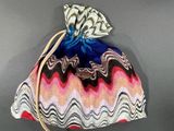 a small bag with a drawstring on top of it