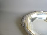 a silver plate with a mirror in it on a table