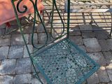 two chairs and a table sitting on a brick patio