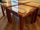 two tables that are sitting on the floor in the room