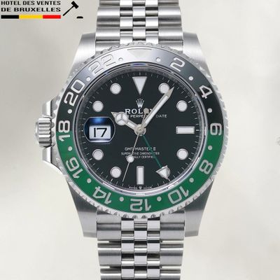 a rolex watch with a green bezel on the bracelet