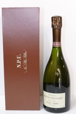 a bottle of wine that is sitting next to a box