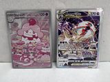 two pokemon cards sitting next to each other on a white surface