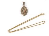 a gold necklace with a picture of a woman on it