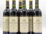 six bottles of wine are lined up on a white surface