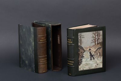 two books are sitting next to each other on a gray surface