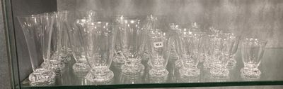 a glass shelf that has many glasses on it