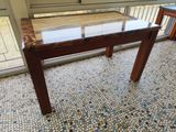 a table with a glass top on a tiled floor