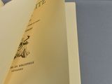 an open book sitting on top of a table next to a tray