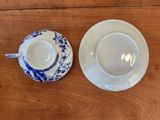 a cup and saucer sitting on a wooden table