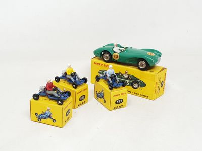 three toy cars sitting on top of boxes on a white surface