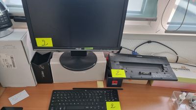 a computer monitor sitting on a desk with a keyboard and mouse