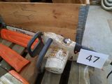 a chainsaw that is sitting on a pallet next to other tools