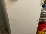 a white refrigerator that is sitting in a room