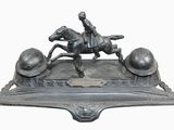 a statue of a man riding a horse on top of a plaque