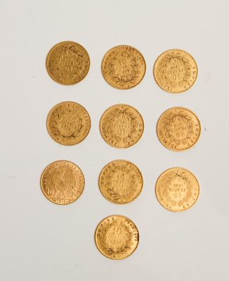 several gold coins are arranged in a triangle on a white surface