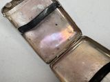 a silver case that is open on a white surface