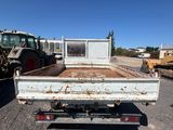 the back of a white truck parked in a parking lot