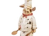 a figurine of a dog wearing a chef ' s hat and holding a spatula